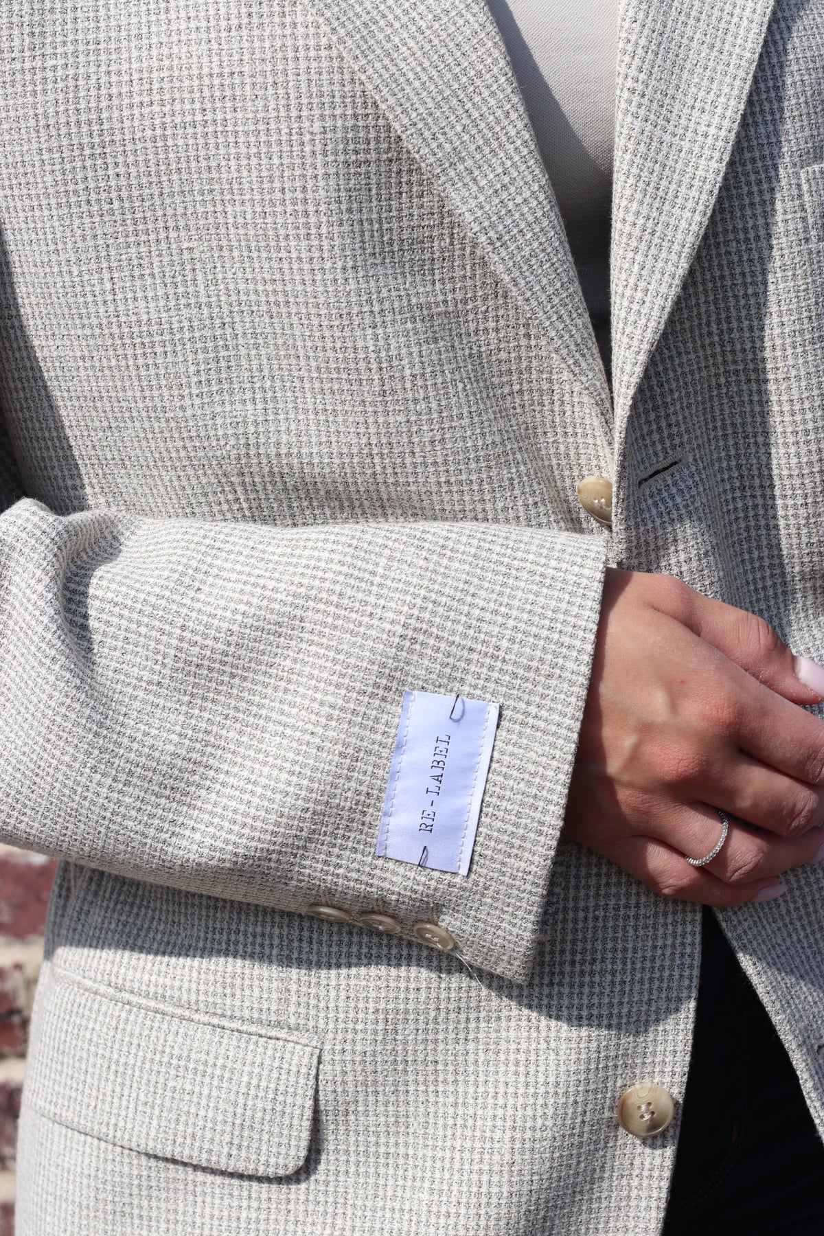 Cream colored blazer with adjustable waist