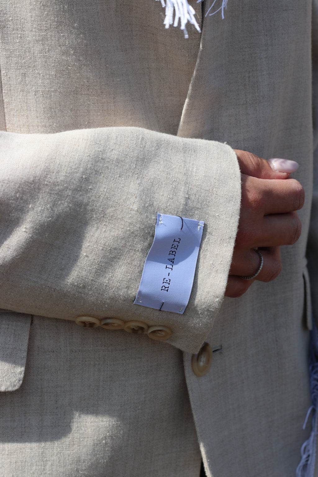 Beige blazer with fringe detail